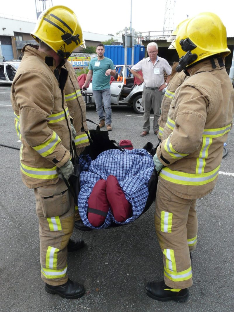 Firefighters carrying a dummy during a rescue training exercise.