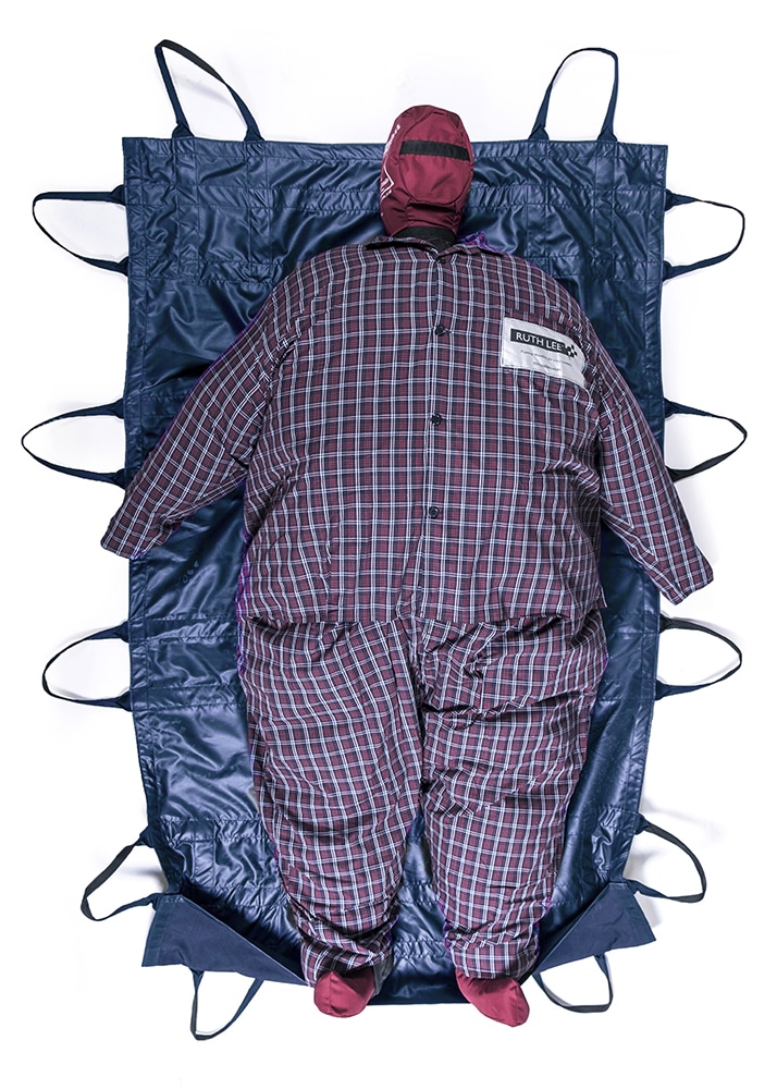 Training rescue mannequin on carry sheet.