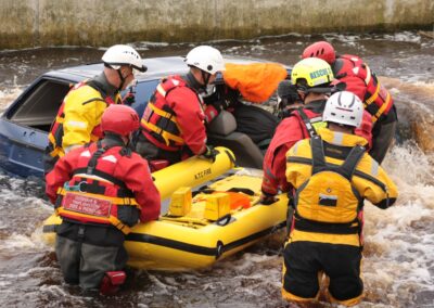 Rescue team assisting with river vehicle extraction