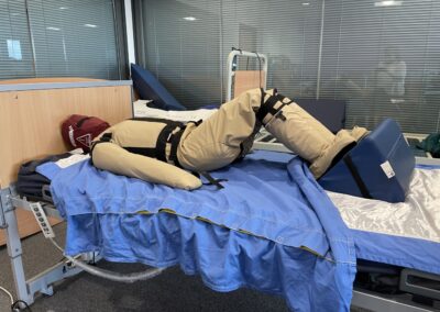 Medical simulation dummy on hospital bed training - Patient Handling Training Manikins