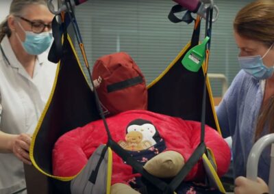 Medical staff using a patient lift sling - Patient Handling Training Manikins