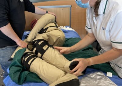 Healthcare workers use patient transfer aid device - Patient Handling Training Manikins