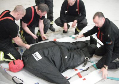 Firefighters practising a rescue operation on a Bariatric (Obese) Training Manikin with stretcher