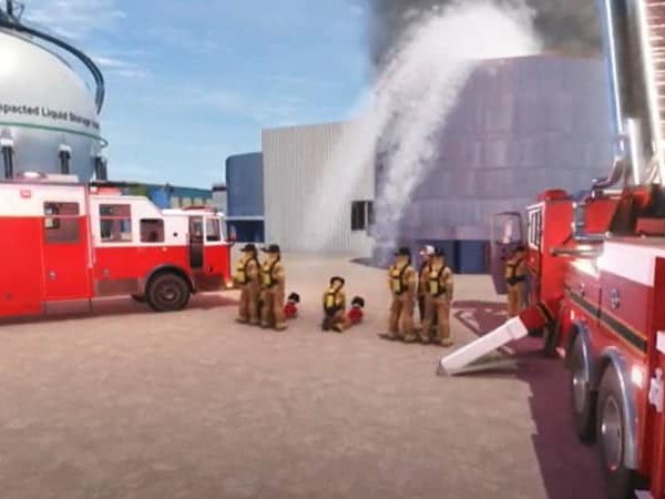 Response Simulator - Firefighters battling industrial blaze with fire trucks.