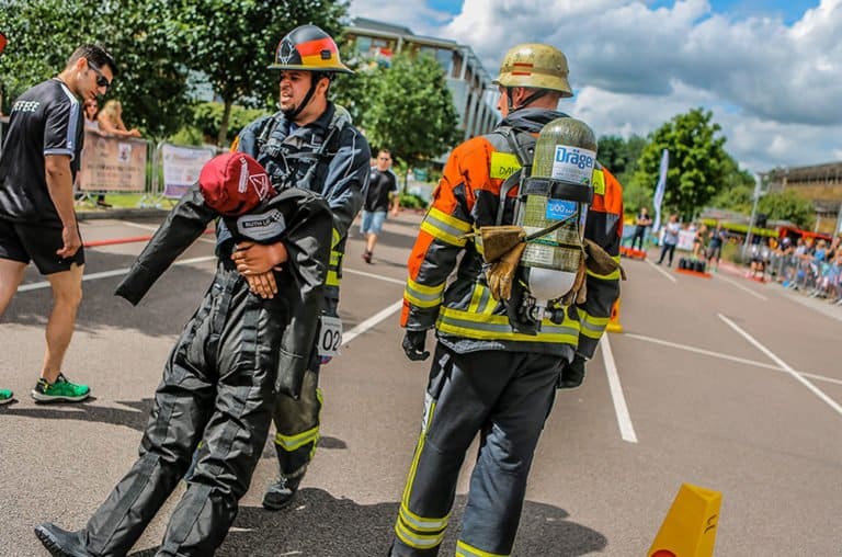 Firefighters in training exercise carrying dummy.