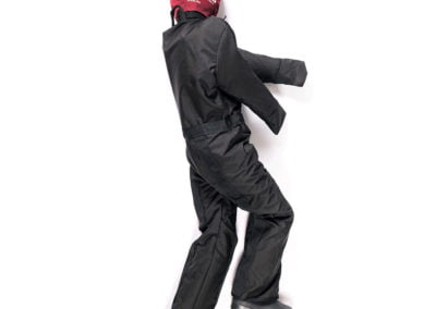 Training dummy in black suit and red headgear.