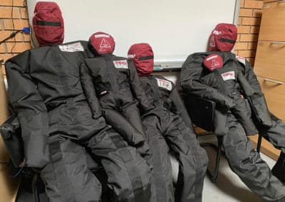Rescue training mannequins in different sizes on chairs.