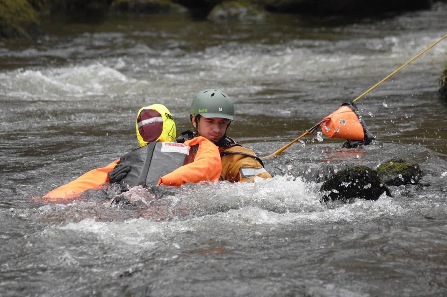 Rescue worker training in flowing river.