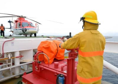 Offshore worker and helicopter on a rig platform.