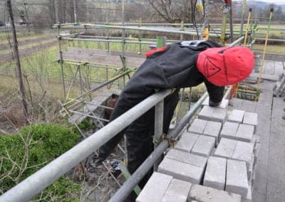 Construction worker demonstrating scaffold ladder safety exercise.