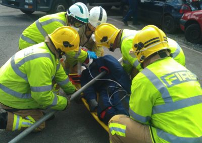 Firefighters rescue injured person in a road accident.