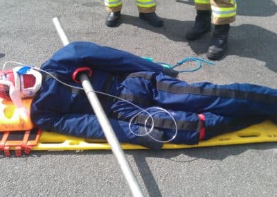 Multi Trauma Training Manikins - Firefighter rescue training with injured dummy on stretcher.