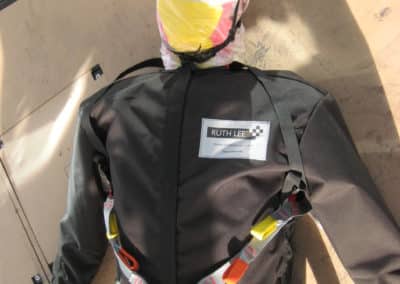 Training manikin wearing harness and safety helmet.
