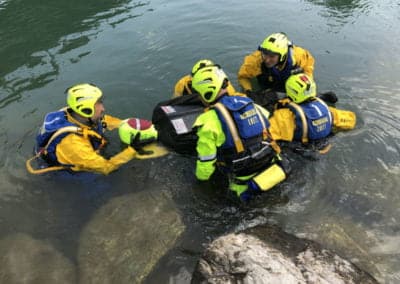 Rescue team practising water rescue techniques.