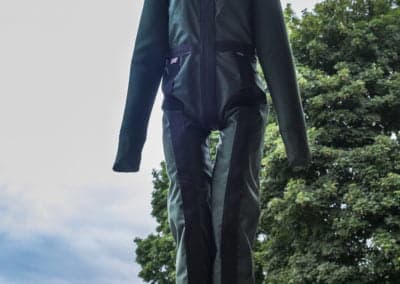 Suspended training mannequin in outdoor safety gear.