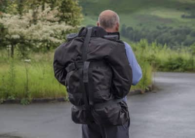 Man carrying a large backpack outdoors