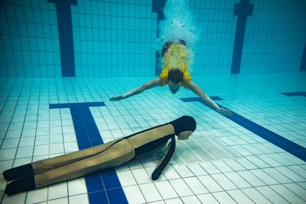Pool Rescue Training Manikin Swimmer practising rescue techniques in a swimming pool.