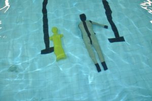 Swimming pool with two floating training mannequins.