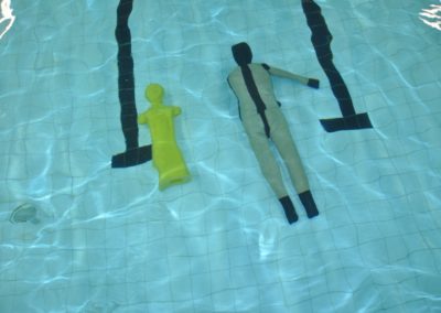 Swimming pool with two floating training mannequins.
