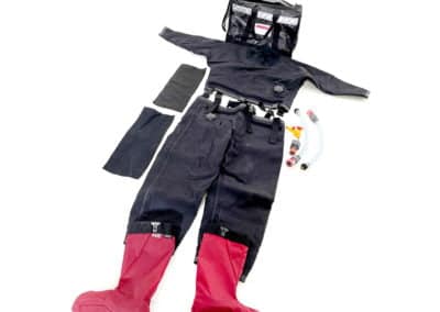 Diving drysuit with red boots and accessories laid out.