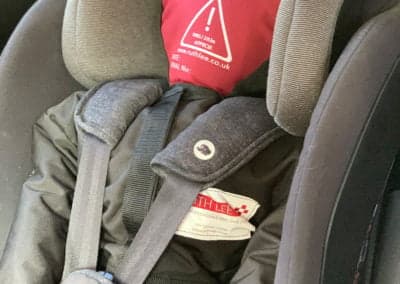 Child car seat with Ruth Lee training mannequin.