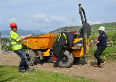 Rescue simulation with construction workers and equipment.