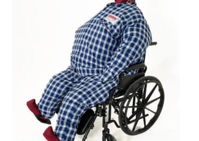Training mannequin in wheelchair for emergency simulations.