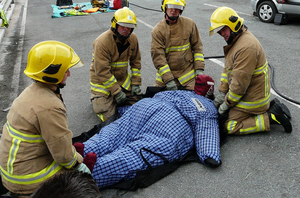 Firefighters assisting a patient during emergency rescue.