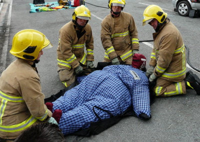 Firefighters assisting a patient during emergency rescue.
