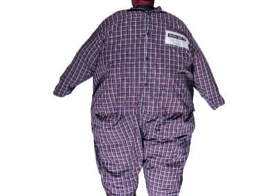 Emergency training bariatric rescue manikin in checked attire.