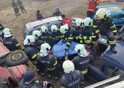 Firefighters rescue person from car during training exercise.
