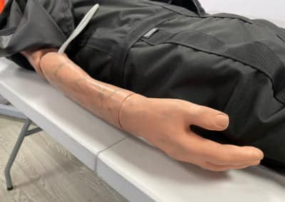 Medical training mannequin arm with visible veins.