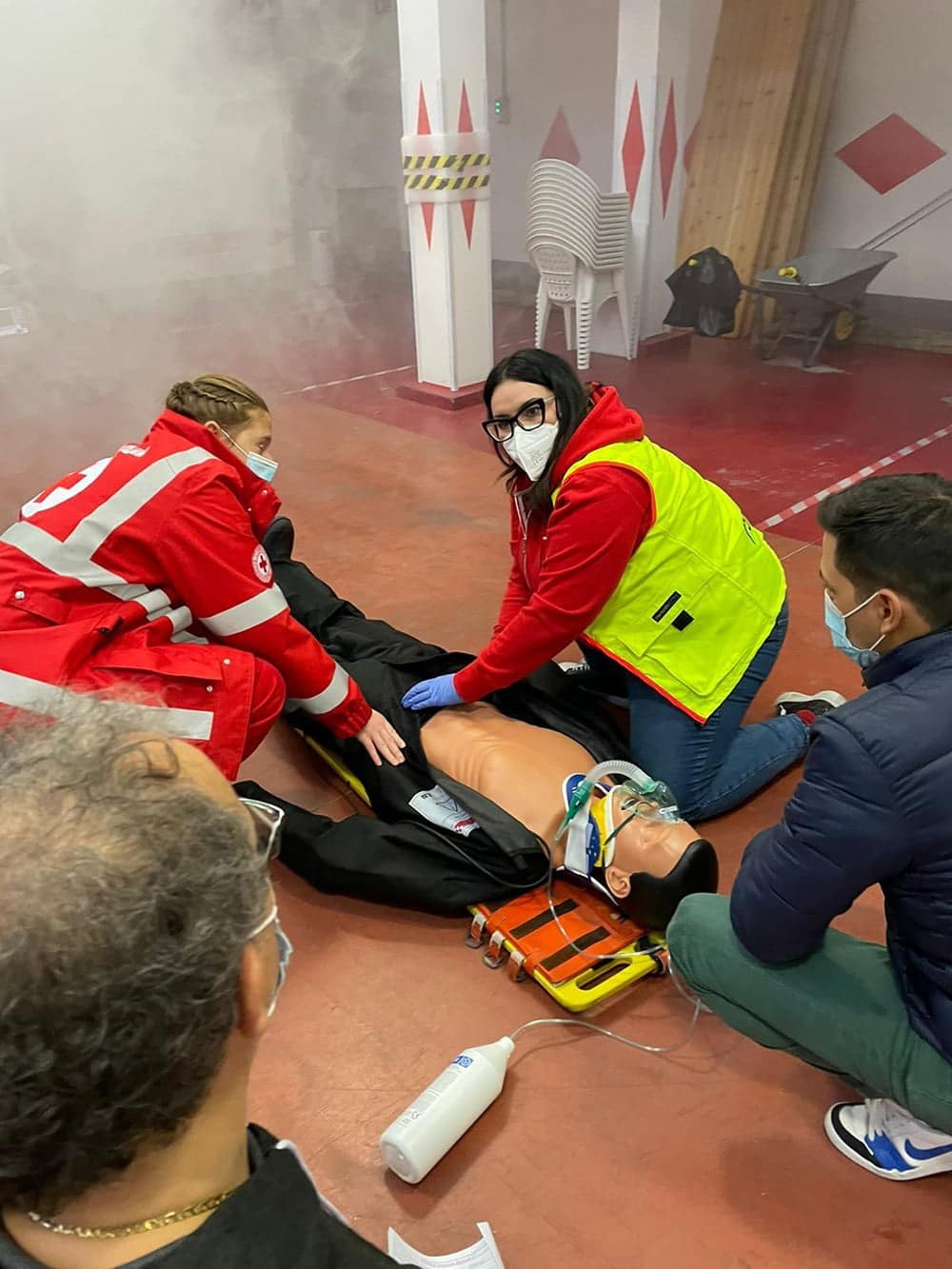 First aid training with CPR practice on a mannequin.