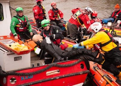Rescue team practising water rescue with a training dummy.