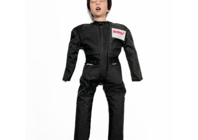 Child Manikin water rescue training - Child wearing black protective suit, laying on white background.