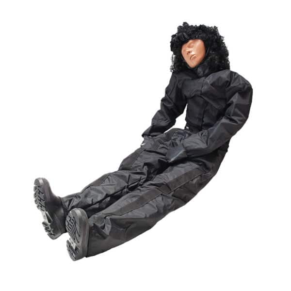 Lifelike training dummy in black suit laying down.