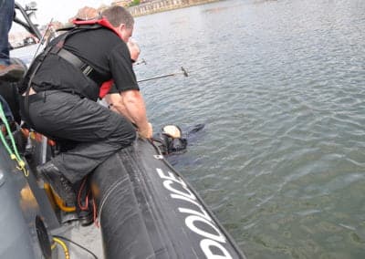 Police team rescues person from water.