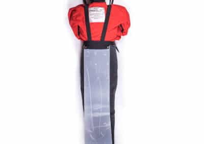 Emergency rescue dummy in red jacket laying down.