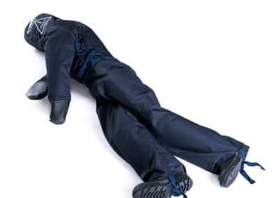 Training dummy in blue suit with tied limbs.