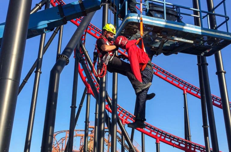 Rescue team practising on rollercoaster with safety harness.