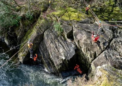 Rescue operation on rocky cliff above strong river