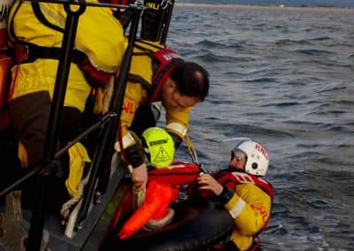 Lifeboat crew rescuing person from sea