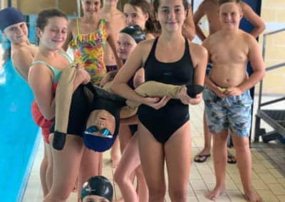 Children having a swimming lesson with an instructor.