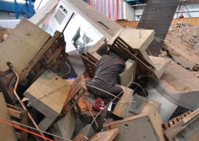 Person trapped under debris after a building collapse.