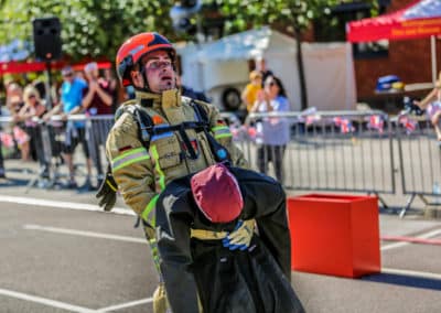 Firefighter participating in a rescue drill competition.