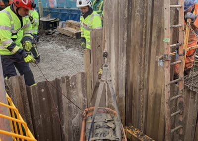 Rescue operation at construction site with stretcher and workers.