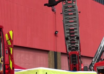 Firefighter demonstrating high-angle rescue techniques.