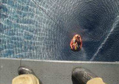 Helicopter rescue operation over the ocean.
