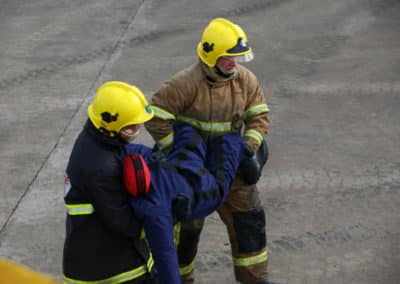 Firefighters carrying a person in a rescue operation.