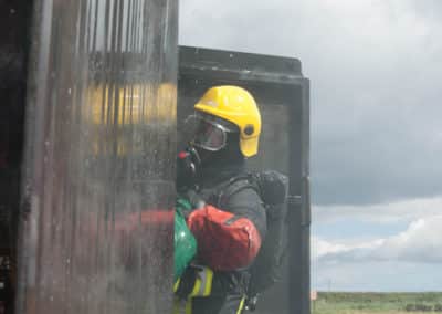 Firefighter training with safety gear and equipment.